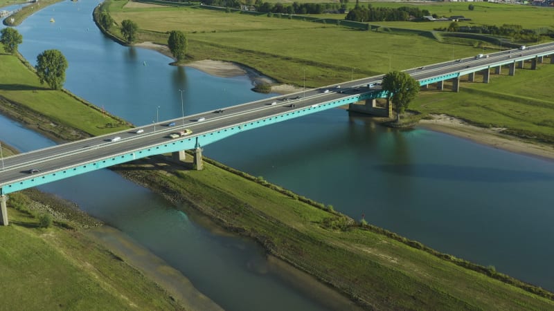 Aerial pull back shot of a river bridge crossing in the Netherlands