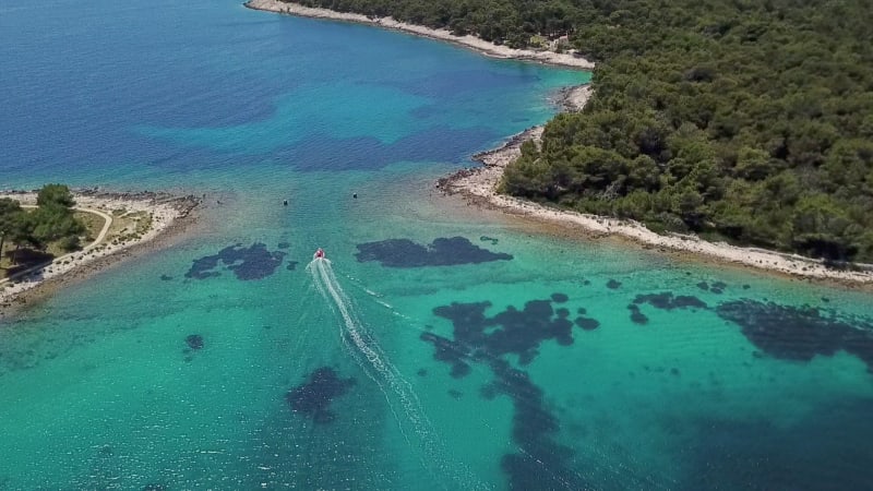 Aerial view of boat sailing at strait between Koludarc island.