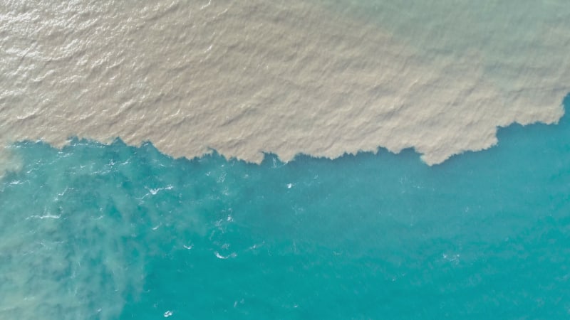 Aerial view of river and sea waters mixing in Rio.