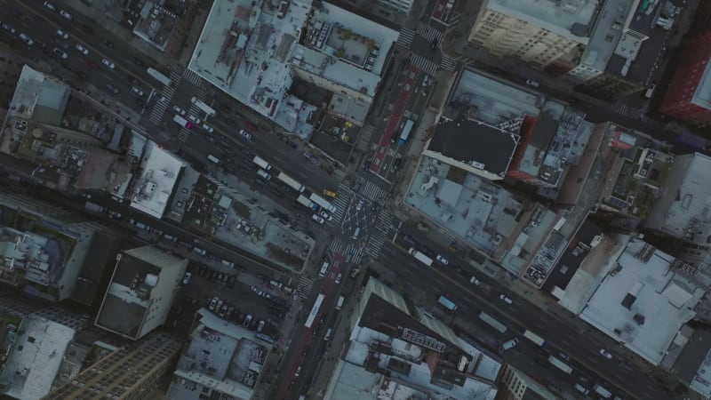 Aerial birds eye overhead top down rotating view of traffic in streets of city. Vehicles passing through crossroads. Manhattan, New York City, USA