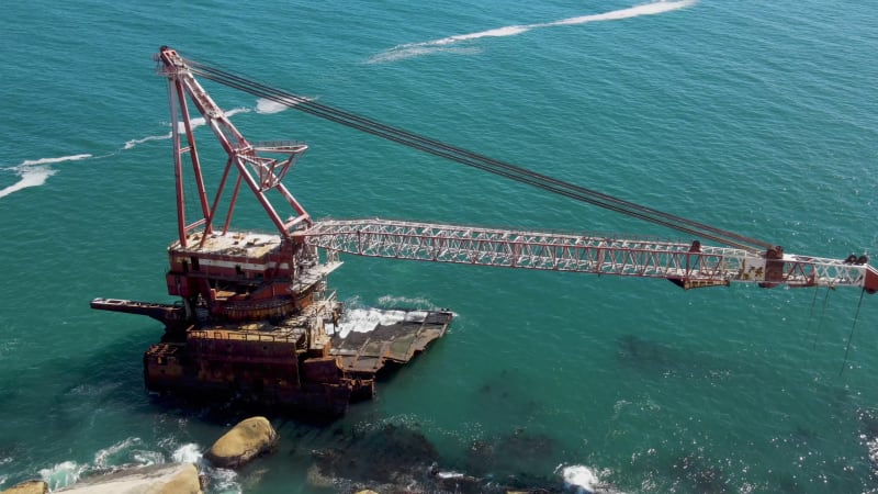 Aerial view of shipwreck crane barge is off the coast of Sandy Bay.