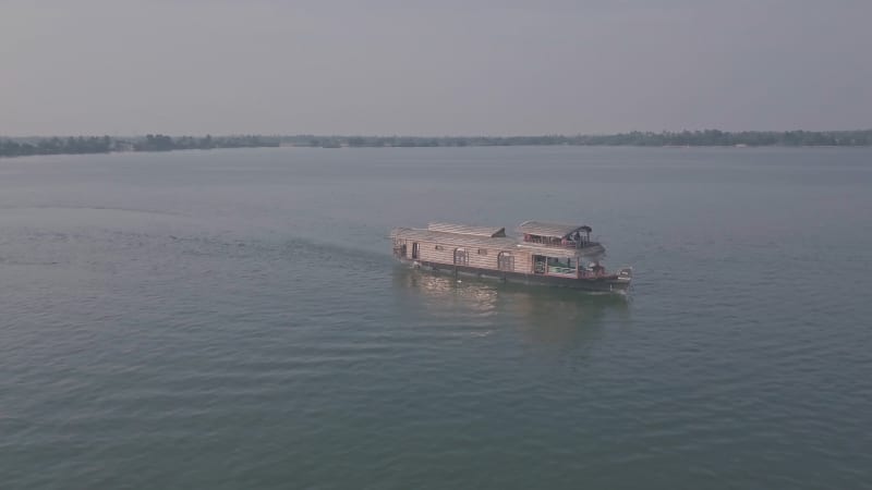 Aerial orbit of large wooden boat on the river