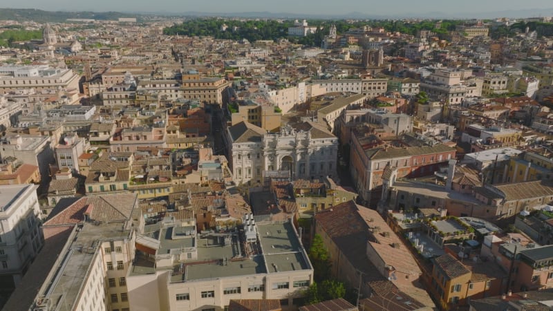 Aerial panoramic view of buildings and landmarks in historic city centre. Fly above narrow streets and old houses. Rome, Italy