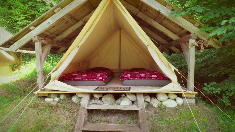 Tracking shot of tent in an eco camping.