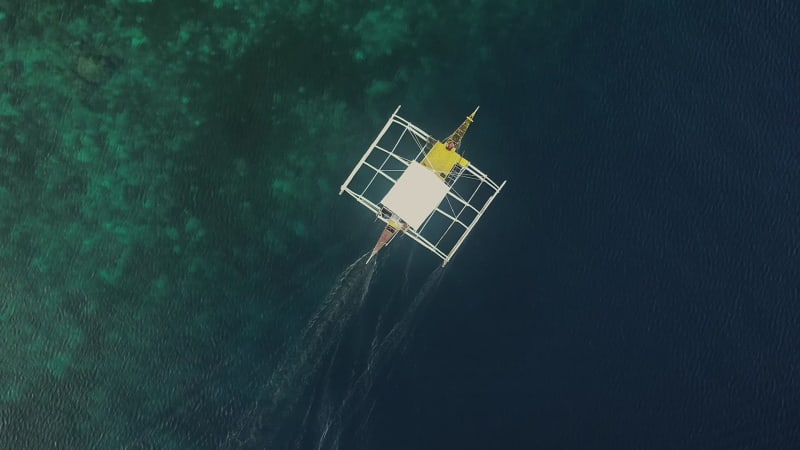 Aerial view of single filipino fishing boat near Lapu-Lapu city.