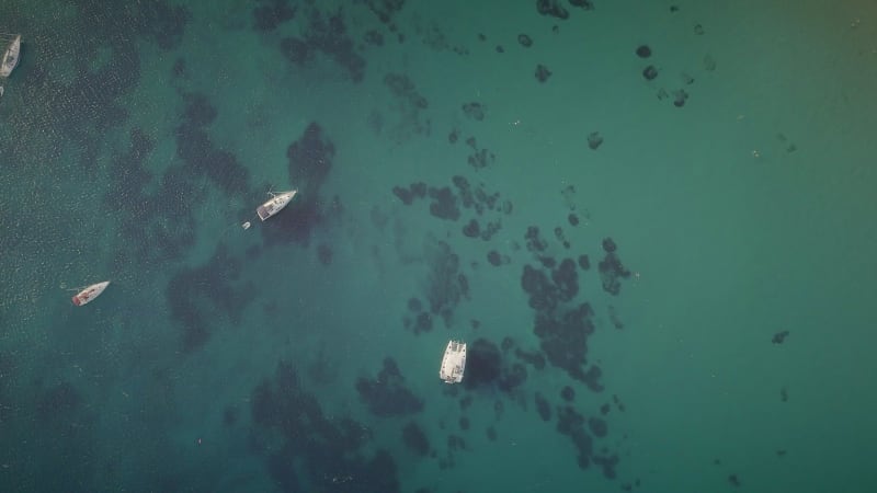 Aerial view of boats parked on relaxing beach in Ydroussa, Andros island.