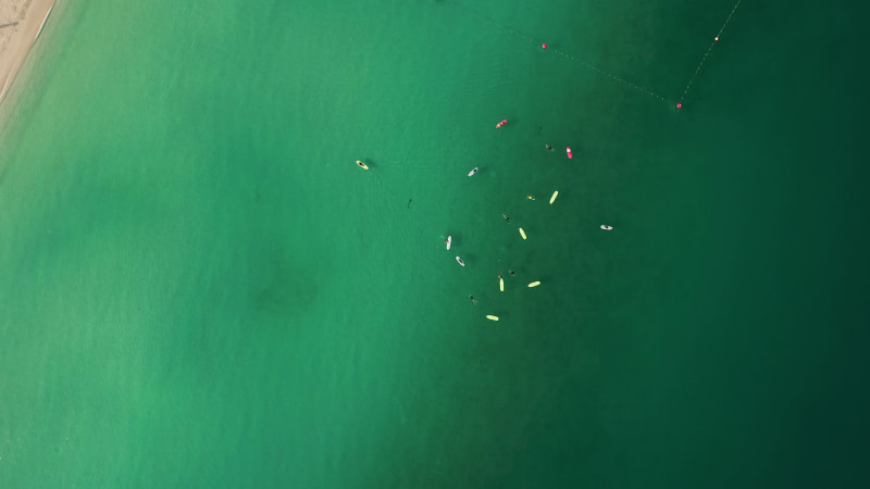 Aerial view of people practicing stand up paddle at Jumeirah beach.