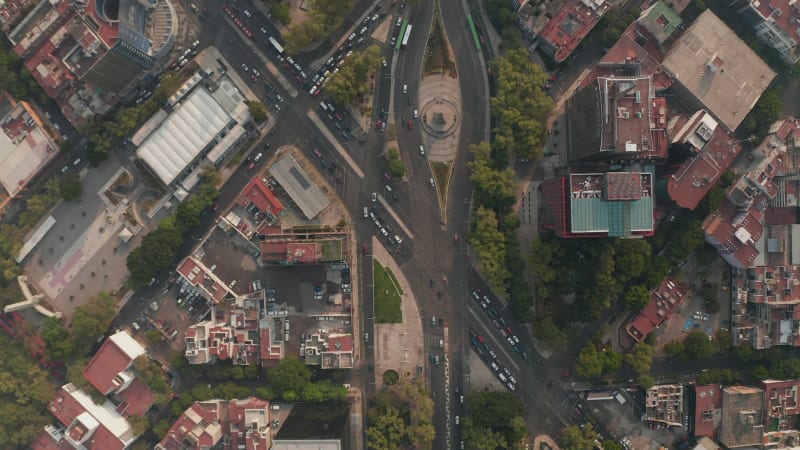 Aerial birds eye overhead top down view of heavy traffic in city streets. Multilane crossroads from drone flying forward. Mexico city, Mexico.