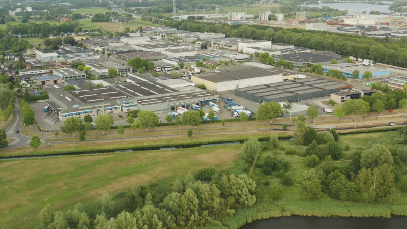 Large industrial building with trucks parked in the front