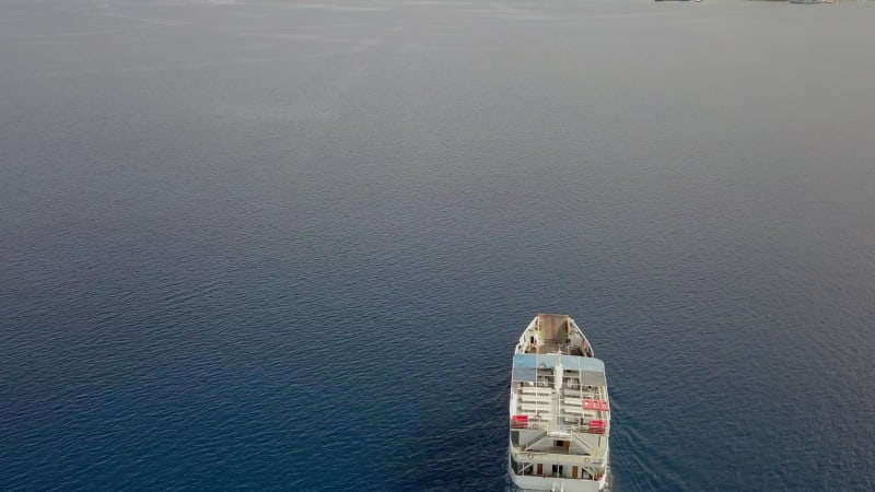 Aerial view behind ferry boat with cars in the mediterranean sea, Kosta.