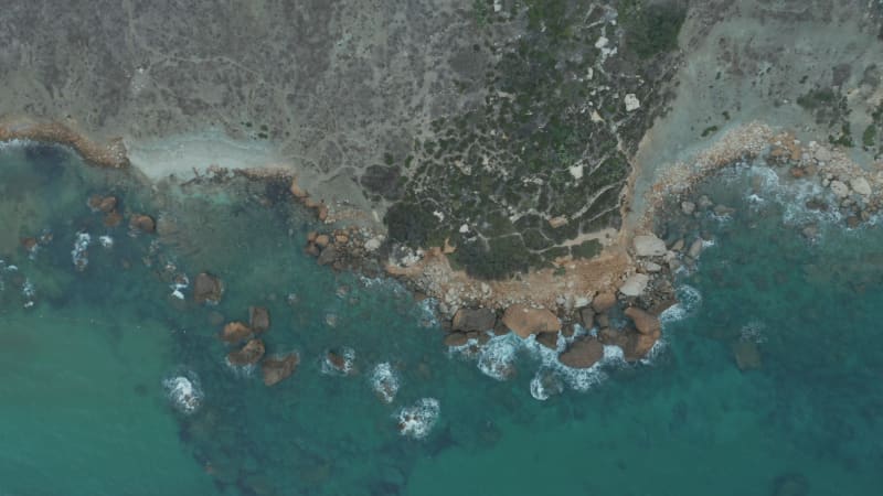 Generic Shoreline of Gozo Malta Island at Sunset, Dark Blue Ocean Waves Crashing from Aerial Birds Eye Overhead Top Down View