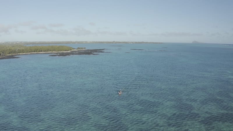 Aerial view of a motorboat along the coast, Mauritius.