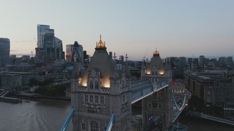 Slide and pan footage of Tower Bridge top walkway in evening. Modern downtown skyscrapers in background. Parallax effect. London, UK