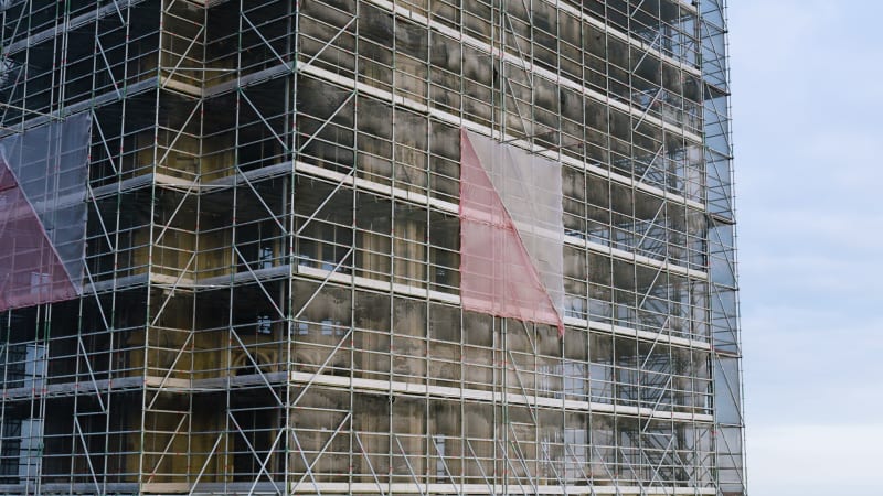 An aerial perspective captures the maintenance and restoration scaffolding the majestic Dom tower in the historic city of Utrecht.