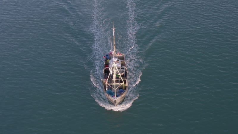 Fishing Boat in the Early Morning Heading Out to Sea