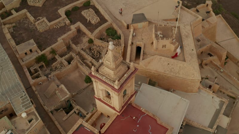 Ruins of Gozo Castle Fort on Malta Island with Tower in beautiful Sand Brown Color, Aerial Birds Eye View slide right