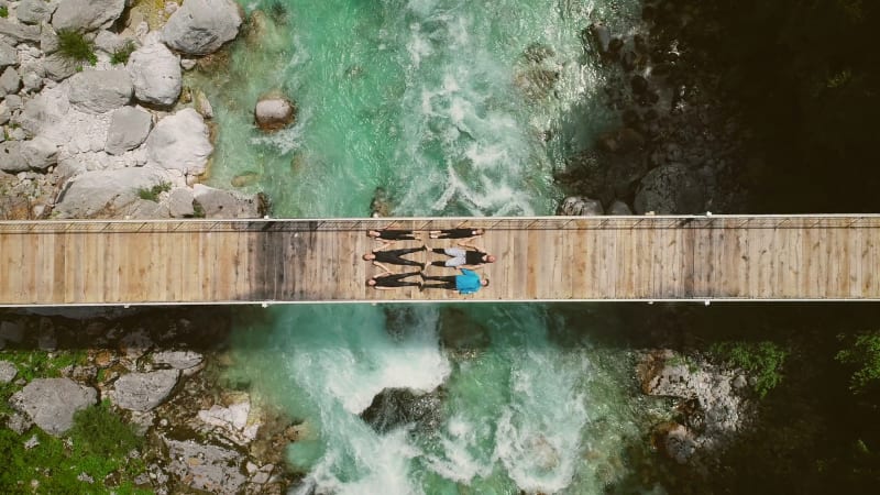 Aerial view of people lying on bridge over.