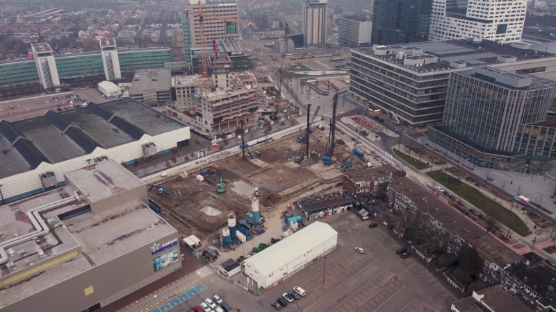 Flying towards heavy duty construction machines on building site, Jaarbeursplein in Utrecht, Netherlands.