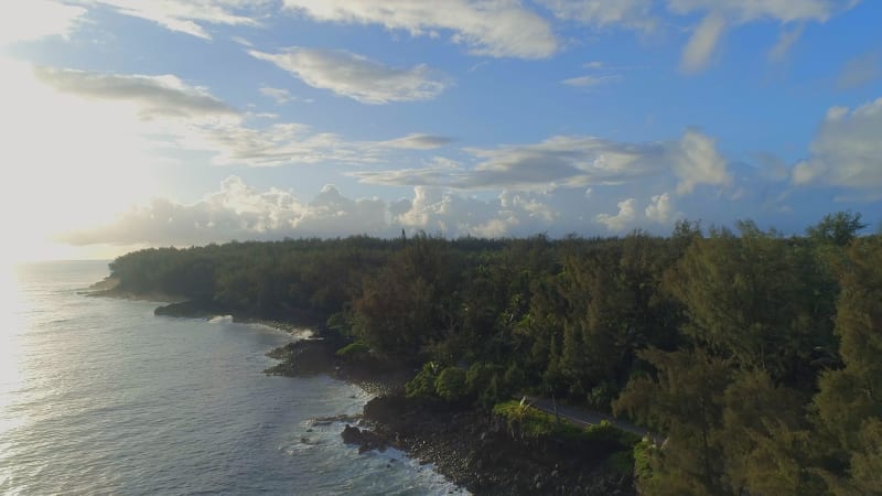 Sunrise Over a Rocky Coastline with the Hawaiian Jungle