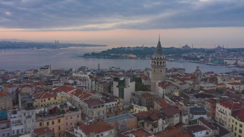 Galata Tower in center of Istanbul Night to Day with Bosphorus and Istanbul skyline, Aerial Hyperlapse Drone Time Lapse forward