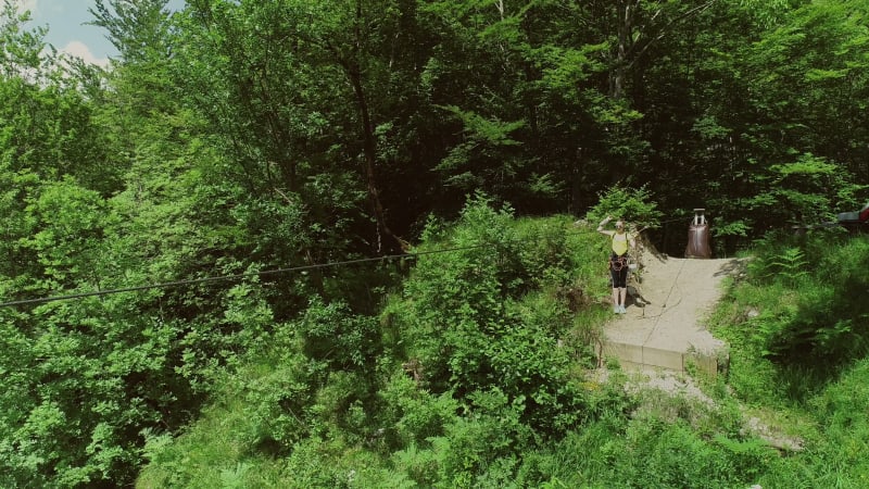 Aerial view of person zip-lining in Soca valley, Slovenia.