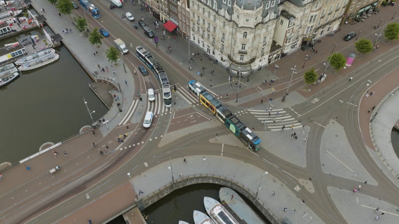 Aerial View of Amsterdam's Canal Intersection and Public Transport