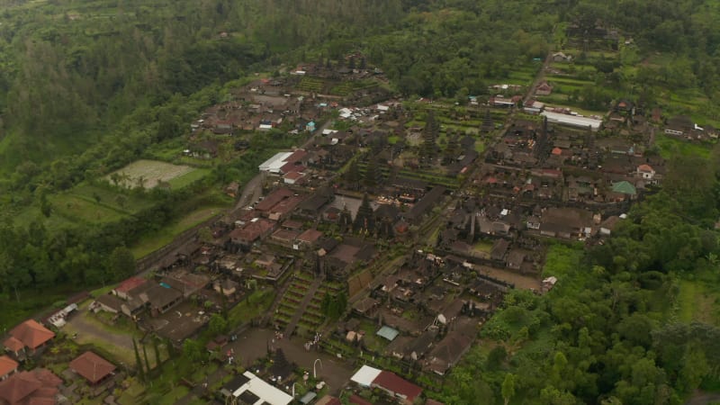 Aerial view of tourists and local people at the Besakih Temple in Bali, Indonesia. Circling shot of old ancient sculptures and buildings at the famous Hindu temple