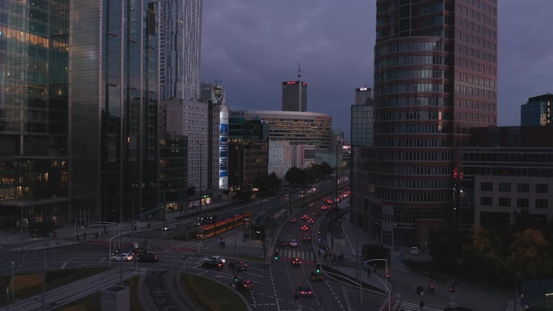 Landing footage of heavy traffic in city centre during evening rush hour. Busy multilane street and road intersection. Warsaw, Poland