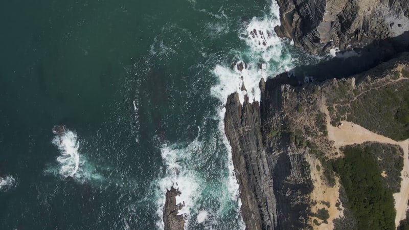 Aerial view of waves breaking on the cliffs, Alentejo, Portugal.