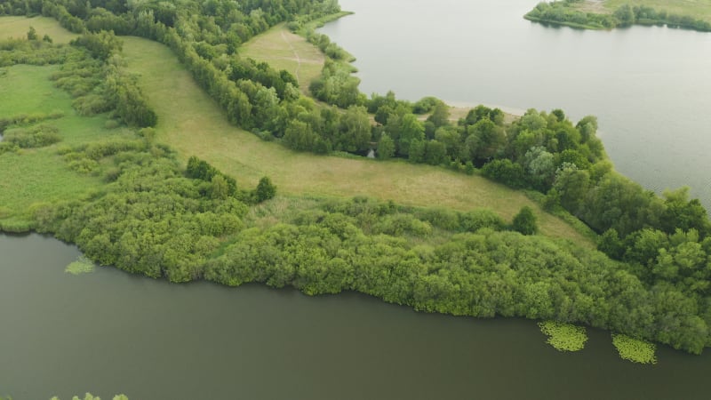 Aerial view of stunning lake scenery with trails and boats in the marina