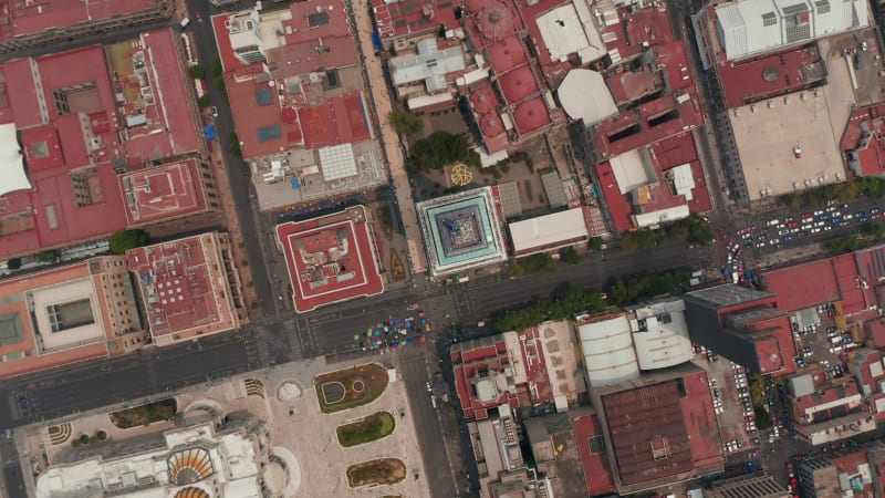 Aerial birds eye overhead top down view of buildings in downtown with Torre Latinoamericana in center. Rotating and slowly zooming in footage. Mexico city, Mexico.