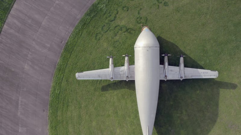 Old Cargo Plane at an Airfield on the Grass Bird's Eye View