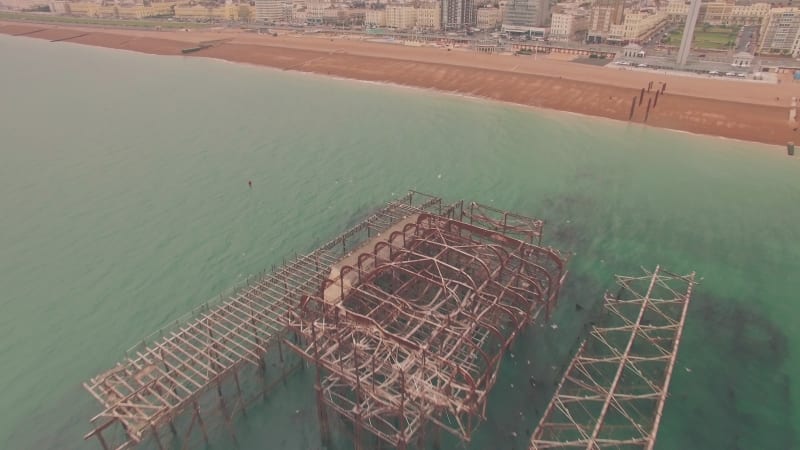 Remains of deteriorating old metal pier off the coast