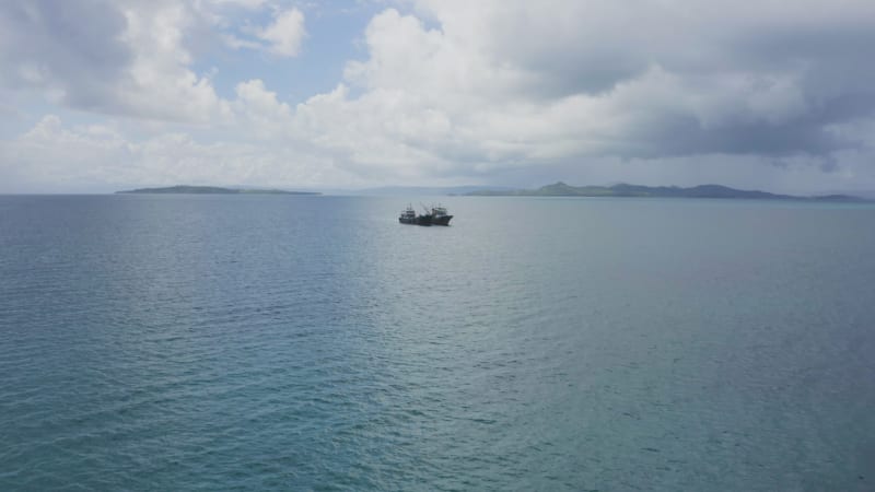 Aerial approach of a pair of boats in open tropical water