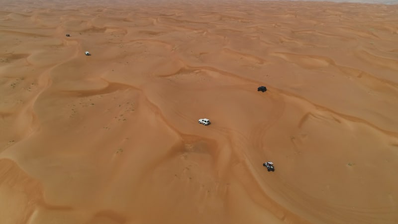 Aerial view group of car driving on a deserted landscape.