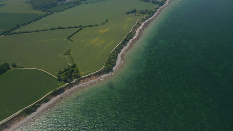 Baltic sea coastline in Brodten, Germany, high aerial drone view of vast background German countryside landscape, day