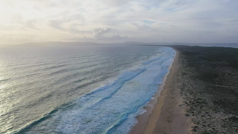 Aerial view of sandy beaches and waves.