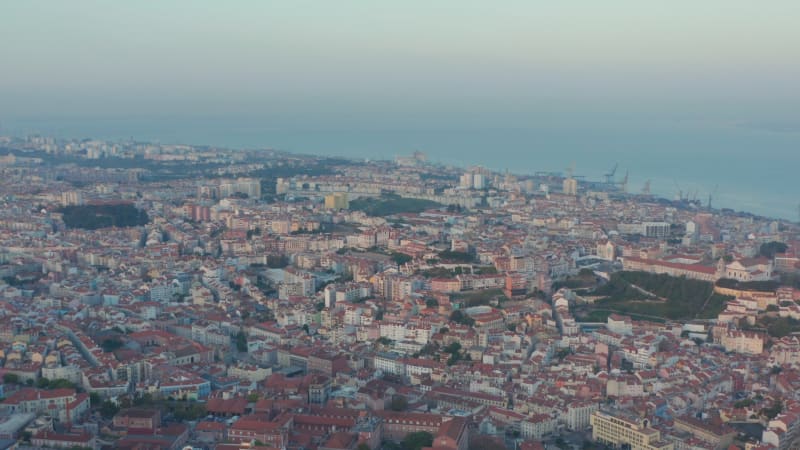 Wide aerial view of rooftops of coastal residential colorful houses in downtown city center of Lisbon, Portugal