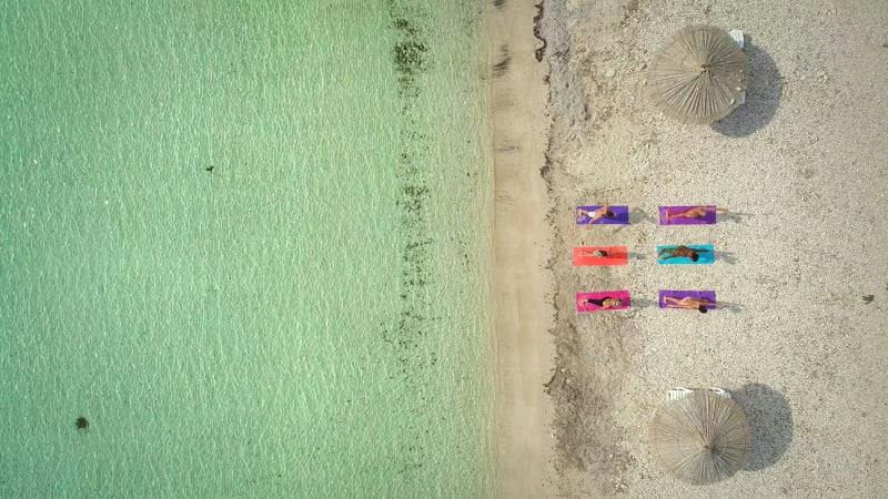 Aerial view of group of people in yoga pose.