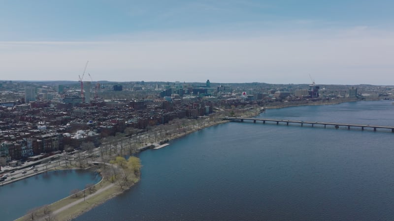 Aerial view of residential and industrial neighbourhood along Charles river. Busy multilane road on waterfront. Boston, USA