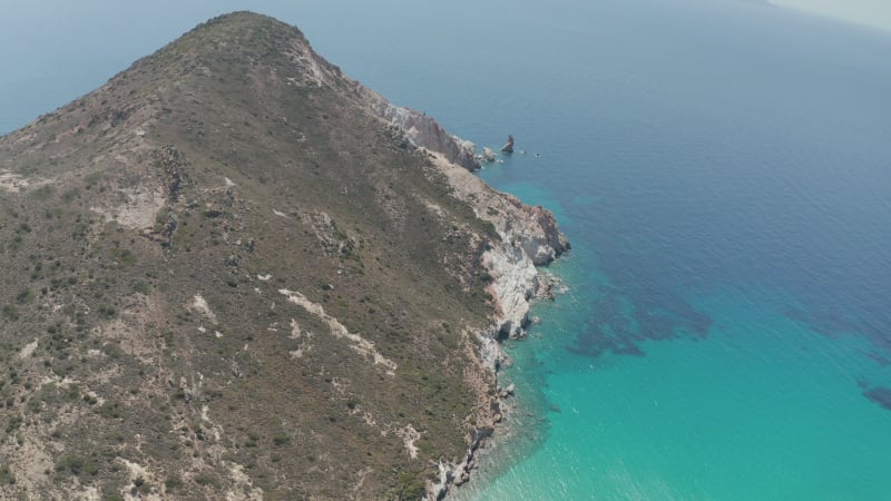 Wide Aerial Establishing Shot of Greek Island Mountain on Milos in Summer with Turquoise Blue Aegean Sea