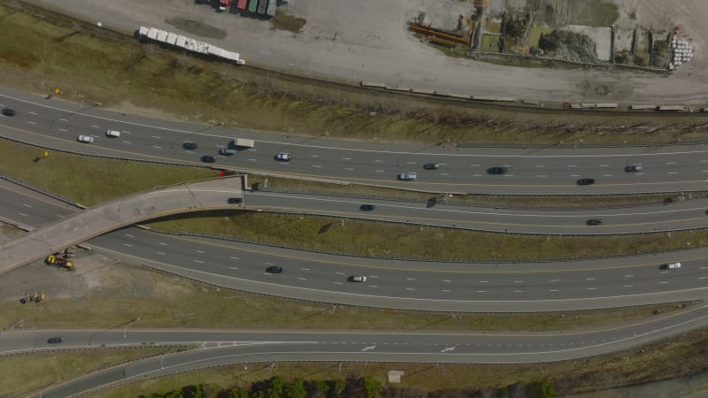 Birds eye shot of traffic on road interchange. Vehicles driving on multilane road, exit ramps and bridges. Boston, USA