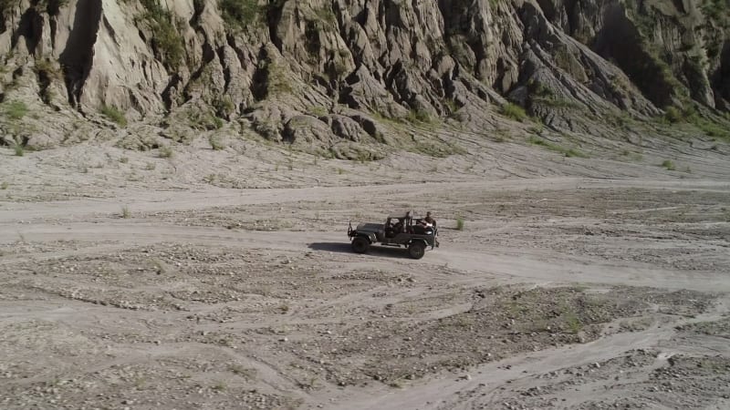 Aerial view of road in valley with a off road jeep in Tarlac.