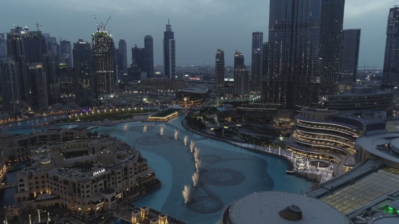 Aerial view of skyscrapers and turquoise fountain in Business Bay.