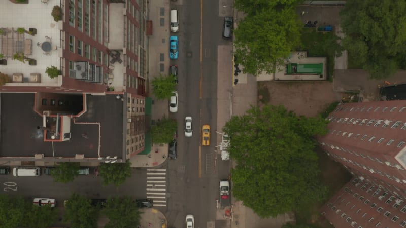 Overhead Top Down Birds View flight over typical New York City Street with car traffic yellow taxi cabs, Manhattan