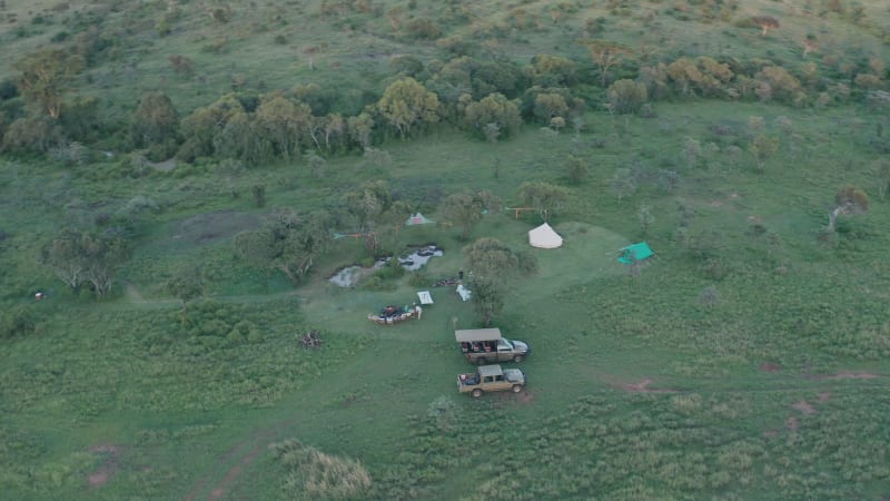 Aerial view of camping site with offroad vehicles in Africa