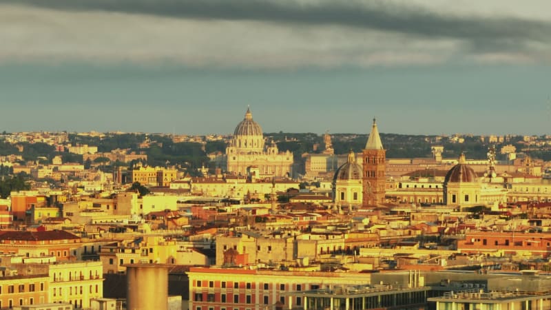 Buildings in historic city centre and famous landmarks in city lit by bright morning sun. Rome, Italy