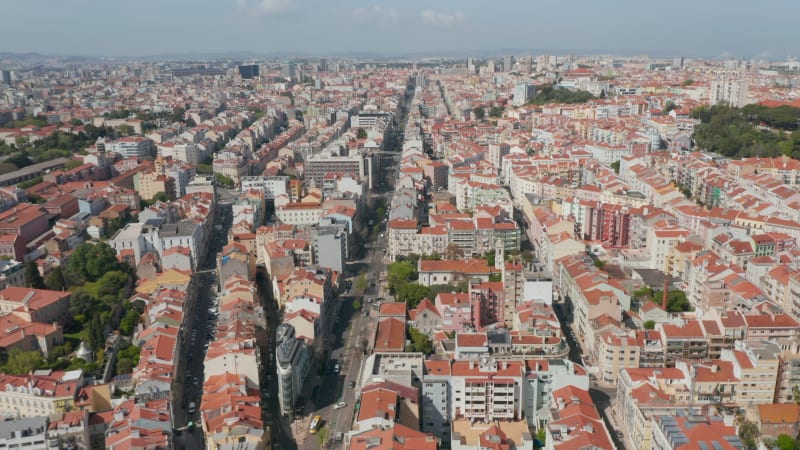 Overhead top down birds eye aerial view of patterns of red rooftops of traditional houses with narrow streets in Lisbon city center