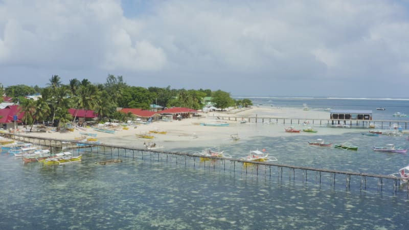 Colorful boats on a shore by boardwalk in the Philippines