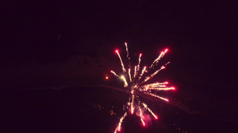 Aerial view of sparkling fireworks display in night sky.